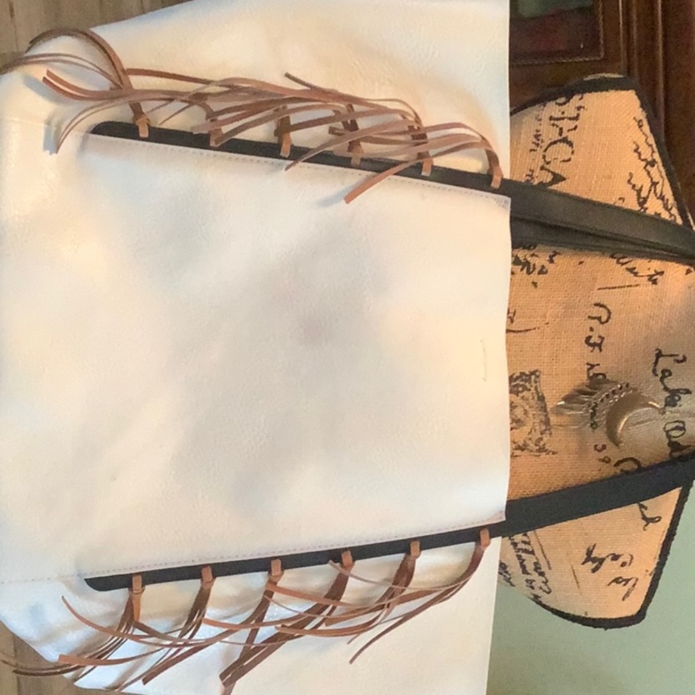 Jessica Simpson large tote. Has red spot on back and black spot on front.